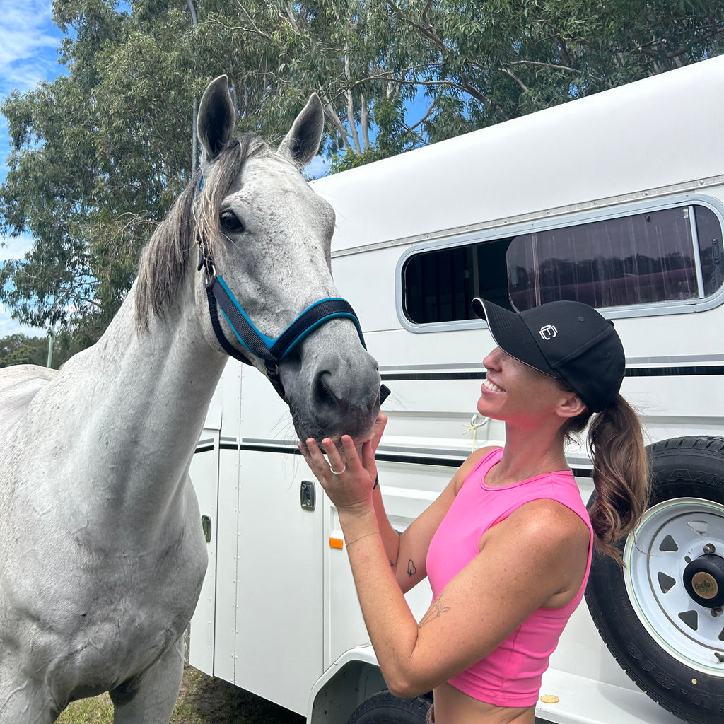 Girl in a cap with a horse