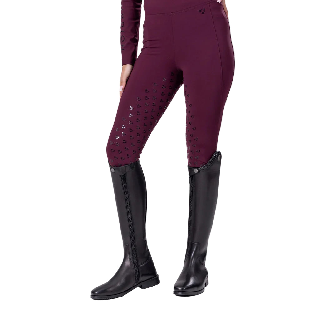 Black cherry riding pants with decorative elements and black riding boots on a white background
