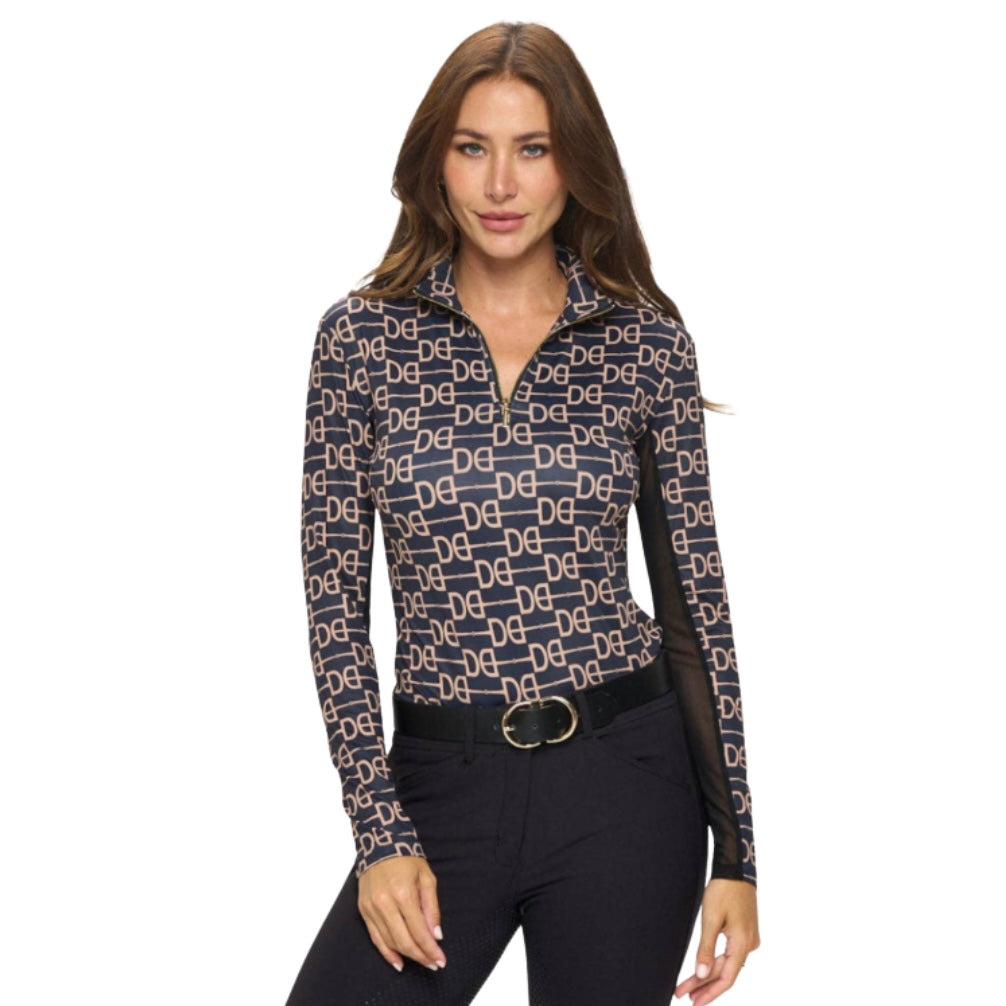 Woman wearing a patterned equestrian base layer and black breeches on a white background