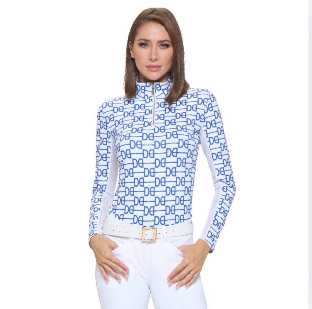 Woman wearing a blue and white patterned long-sleeve equestrian baselayer with a white background