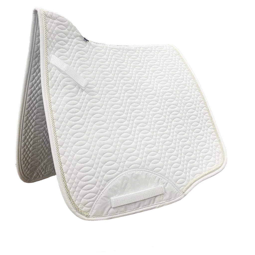 White quilted saddle pad with champagne coloured trim on a white background
