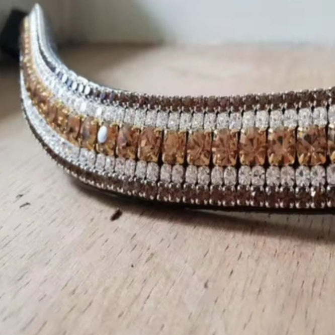 Decorative browband with brown and silver beads on a wooden surface